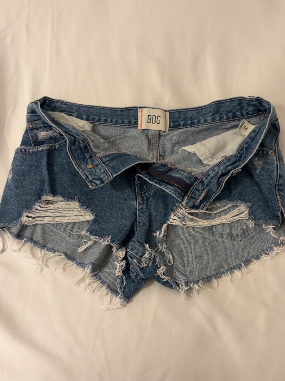 BDG Frayed Distressed Denim Cutoff Shorts in Blue Wash